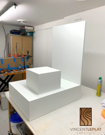Estrade et présentoir pour un espace commercial professionel. Conçu et fabriqué par Vincent LEPLAT, ébéniste près de Lille. Les meubles sont réalisés sur mesure en stratifié blanc Egger.